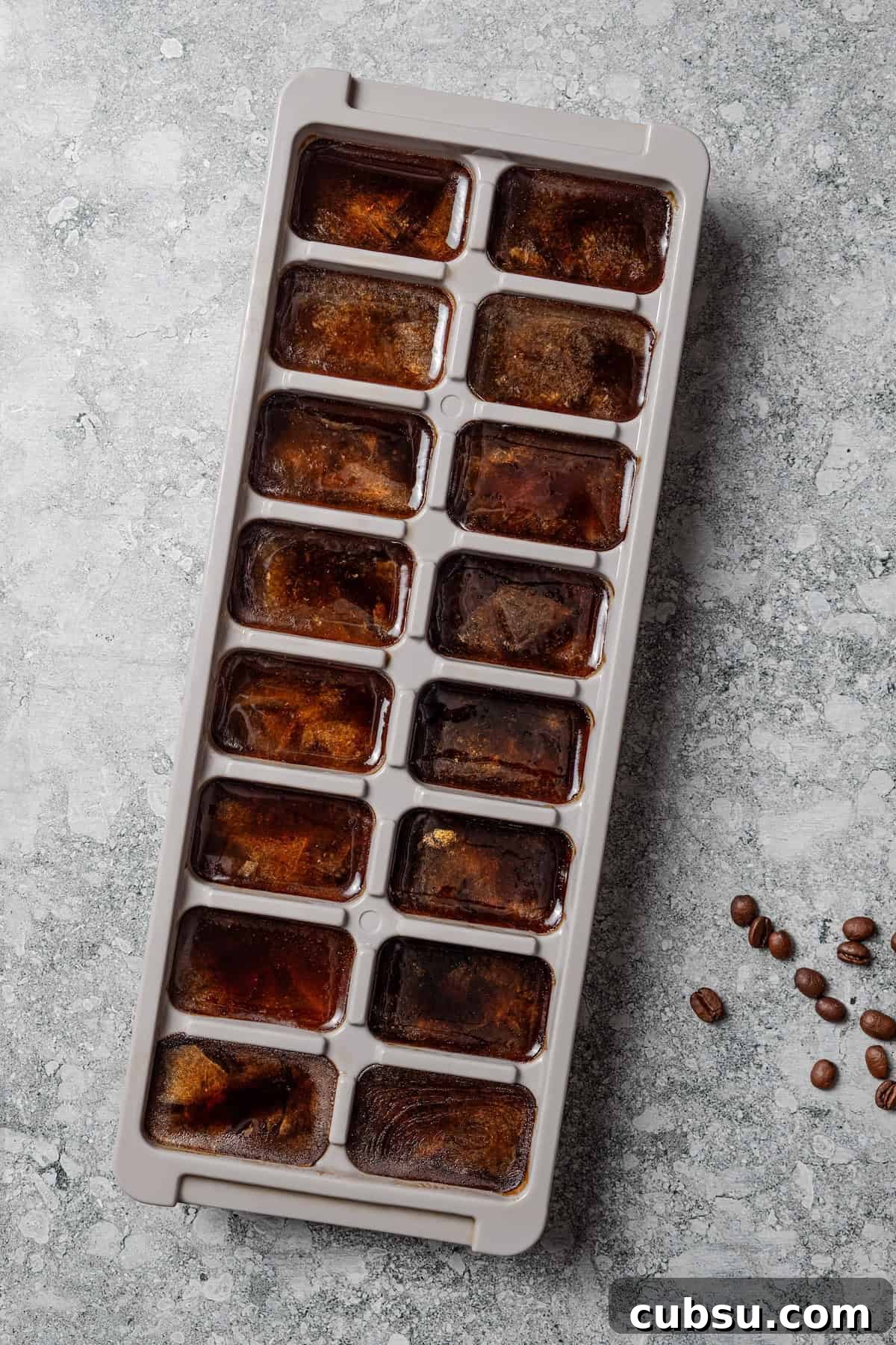 Freeze the coffee. Frozen coffee in an ice cube tray.