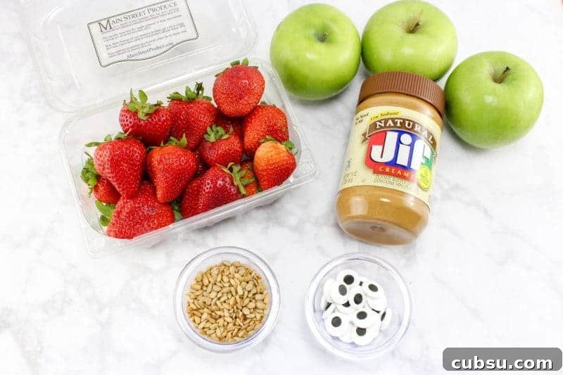 Strawberries, green apples, peanut butter, sunflower seeds, and candy eyes.
