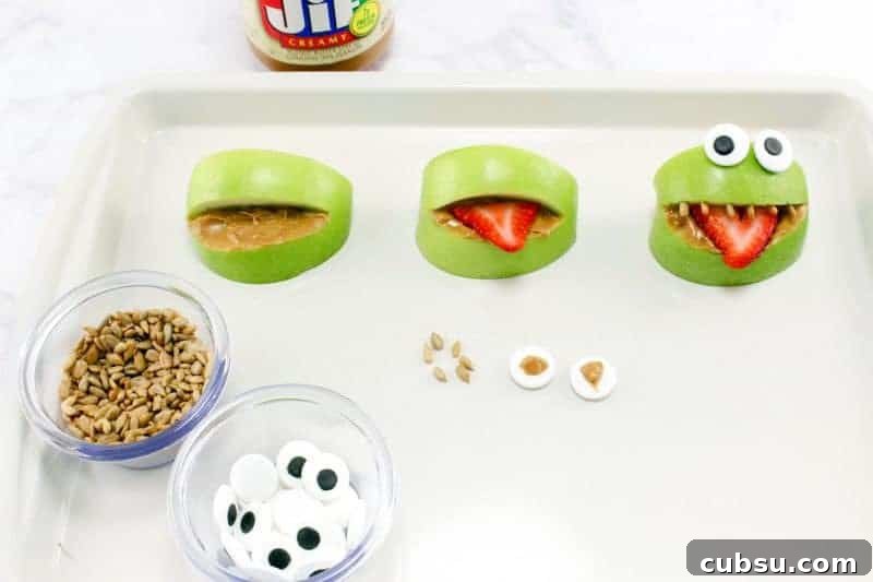 Apples on sheet pan being turned into monsters.