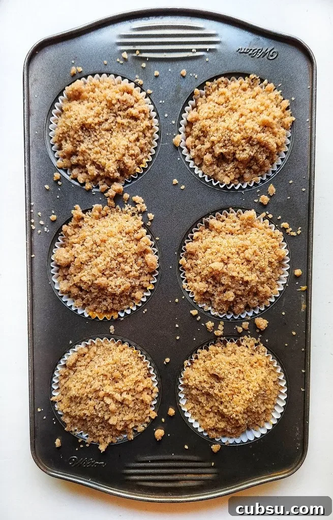 add the crumb topping on top of the muffin batter