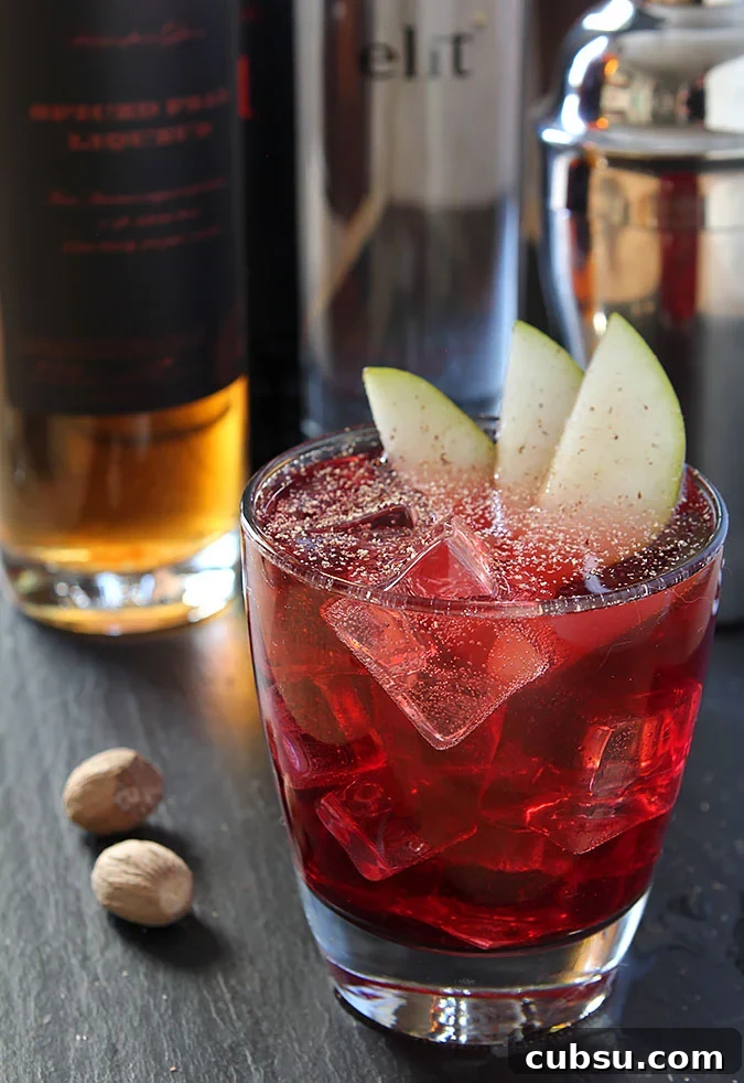 Vodka, Red Wine and Spiced Pear Liqueur Vodka, Red Wine and Spiced Pear Liqueur Cocktail Garnished with Pear Slices and Nutmeg