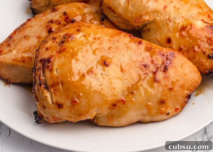 Juicy and moist glazed chicken served on a white plate.