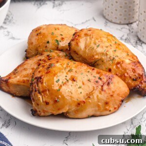 Golden chicken breasts cooked with a shiny glaze of peach preserves and seasonings.
