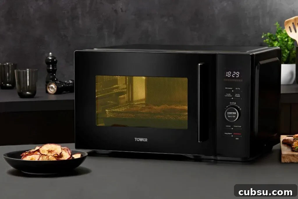 Tower Air Fryer Microwave Review: Honest Performance and Tips 2 An air fryer microwave on a kitchen worktop with food in a bowl next to it