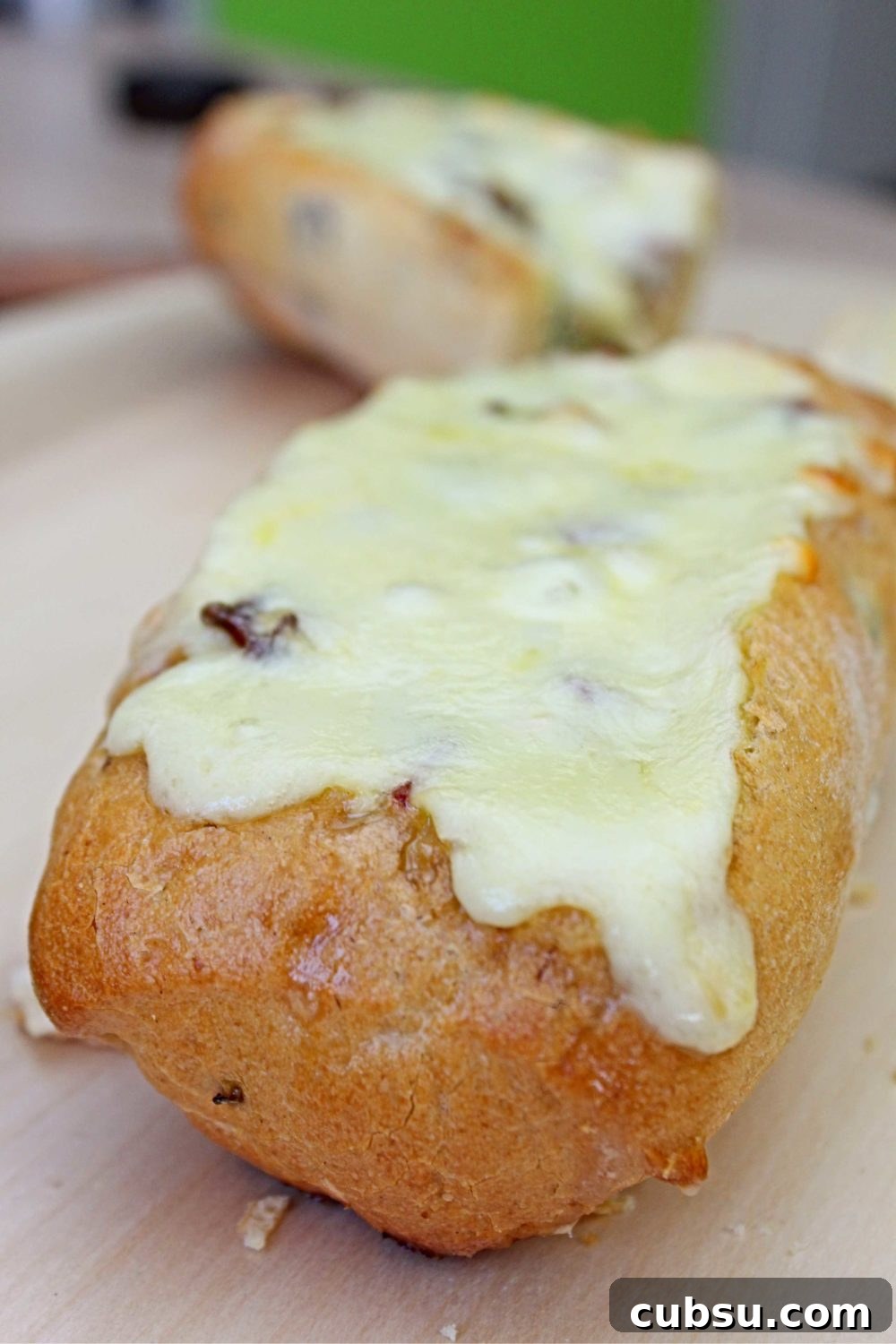Egg boat for breakfast with baked omelette with ham, cheese, mushrooms and scallion, on a cutting board