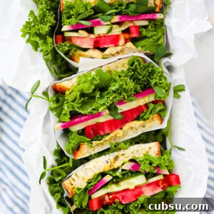 An overhead shot of sliced vegetarian sandwiches.
