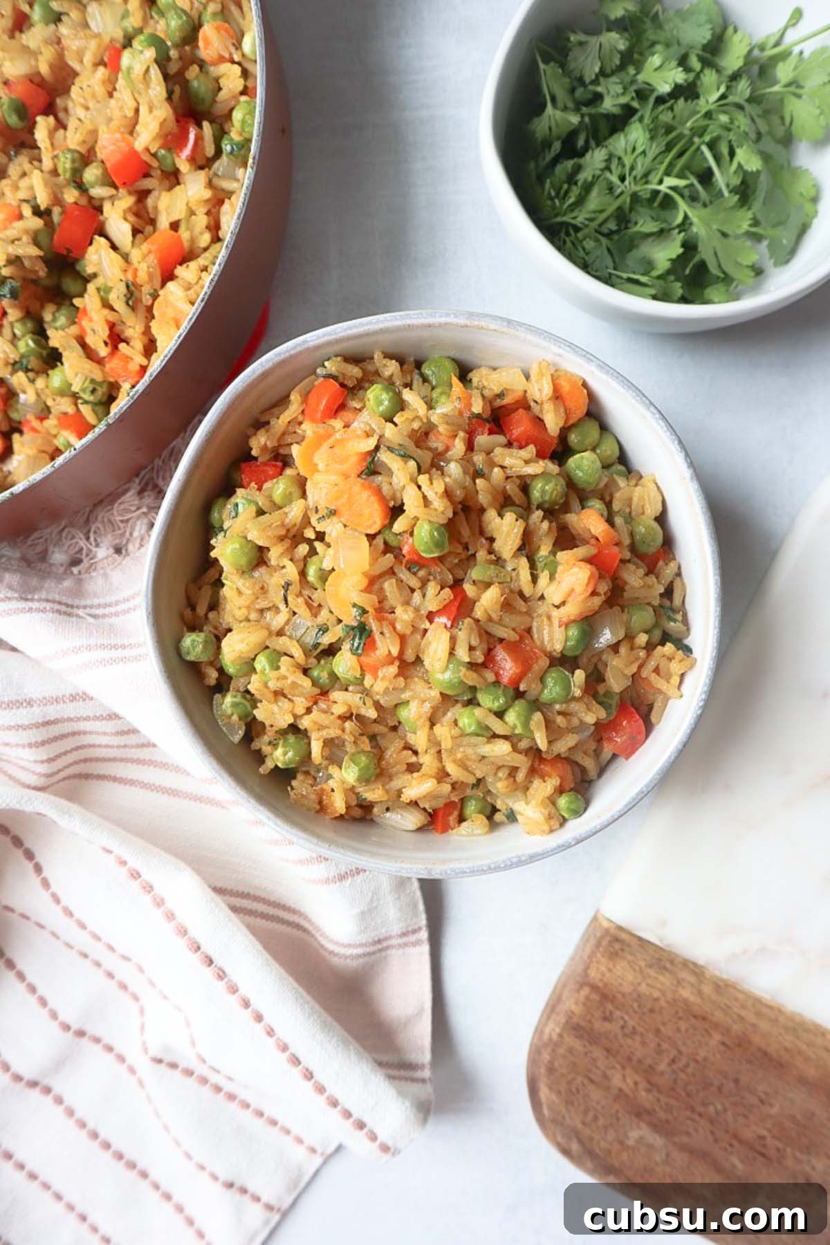 Green Curry Fried Rice Recipe: Authentic Thai Flavor in 30 Minutes 5 green curry fried rice in a white bowl with carrots, peas, and pepper, topped with fresh cilantro