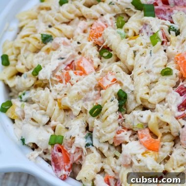 creamy seafood pasta salad in a white ceramic bowl