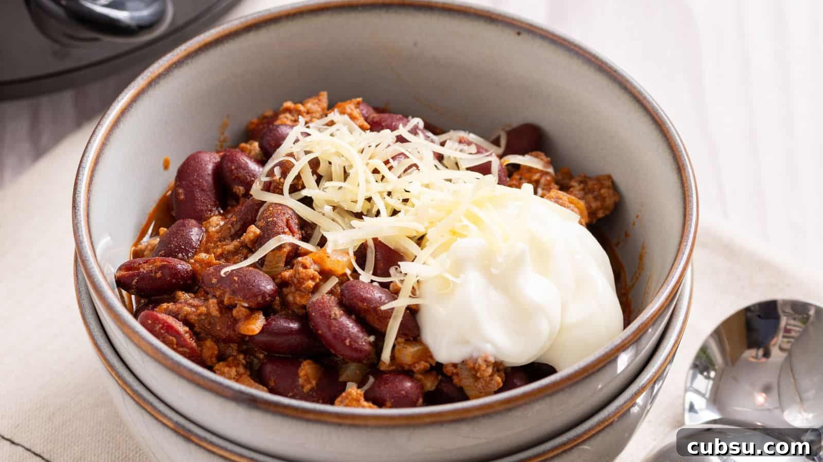 17 Timeless Grandma Recipes You Need to Try Now 15 Bowl of chili with shredded cheese and a dollop of sour cream on top.