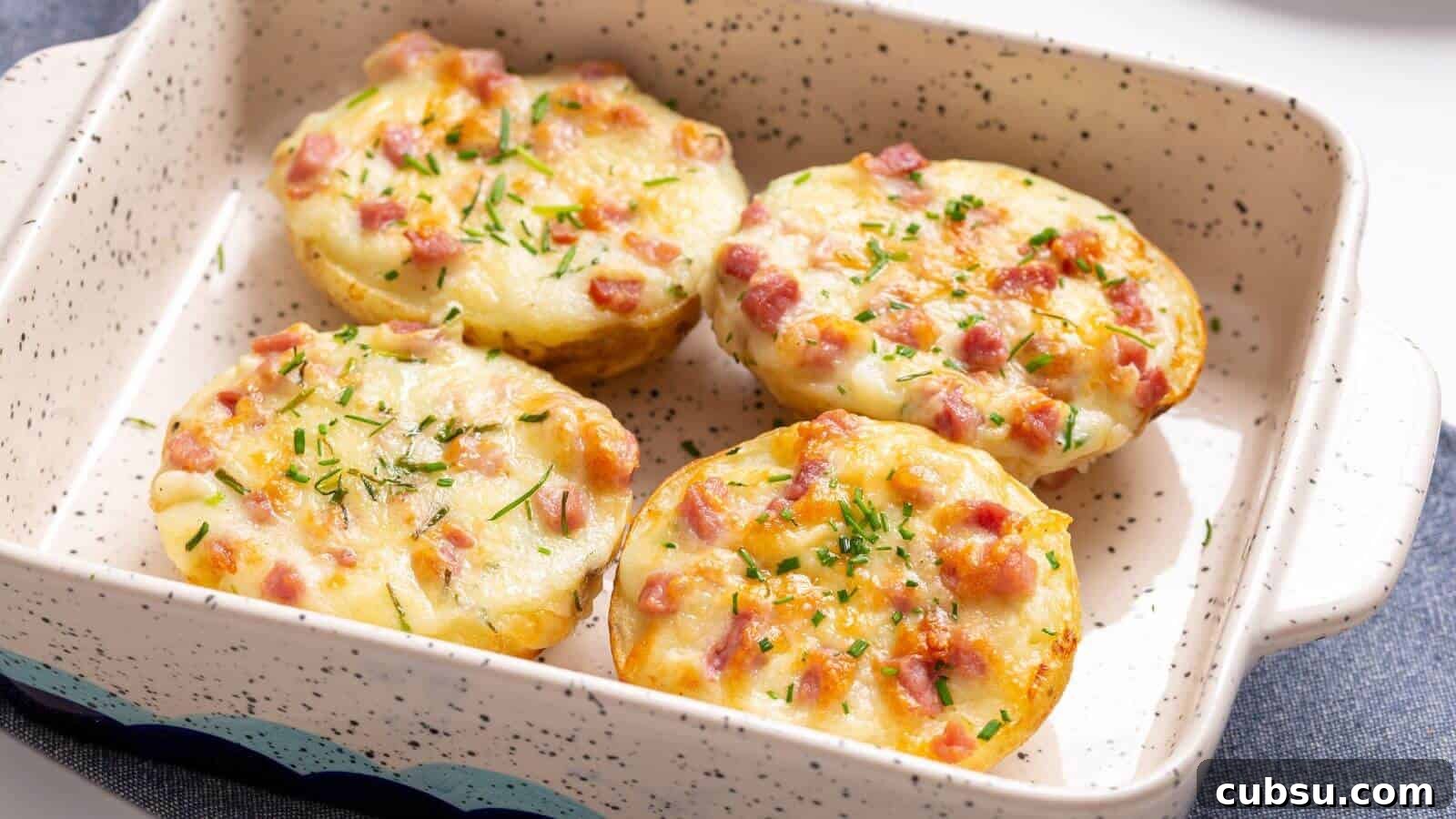 17 Timeless Grandma Recipes You Need to Try Now 17 A baking dish containing four twice-baked potatoes topped with melted cheese and diced ham, garnished with herbs.