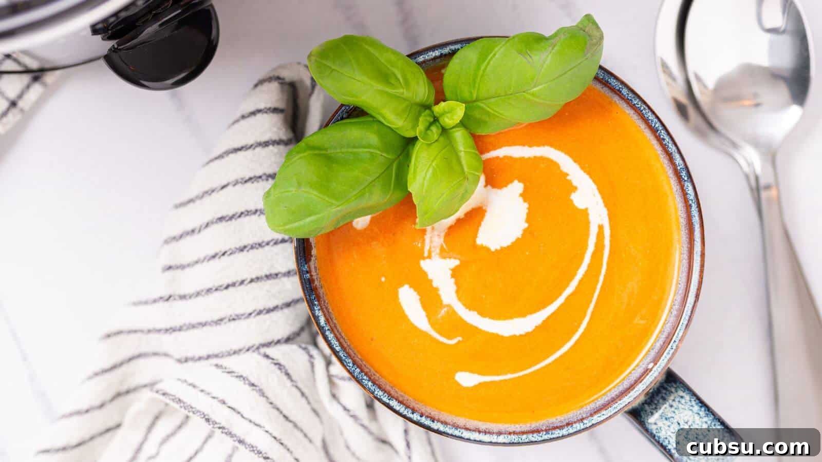 17 Timeless Grandma Recipes You Need to Try Now 10 Bowl of creamy tomato soup garnished with basil leaves.