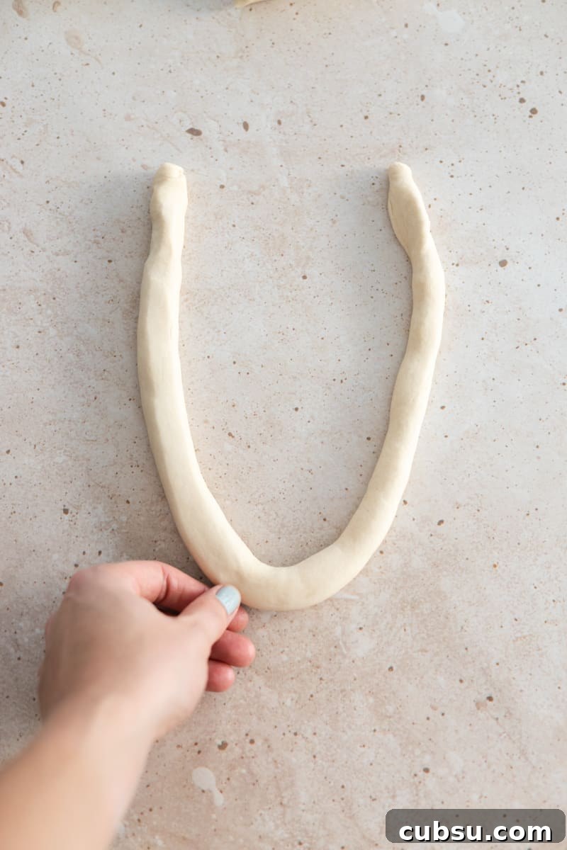 Crispy Sourdough Discard Pretzels: Tangy Soft-Baked Recipe 9 Dough rope in a U shape.