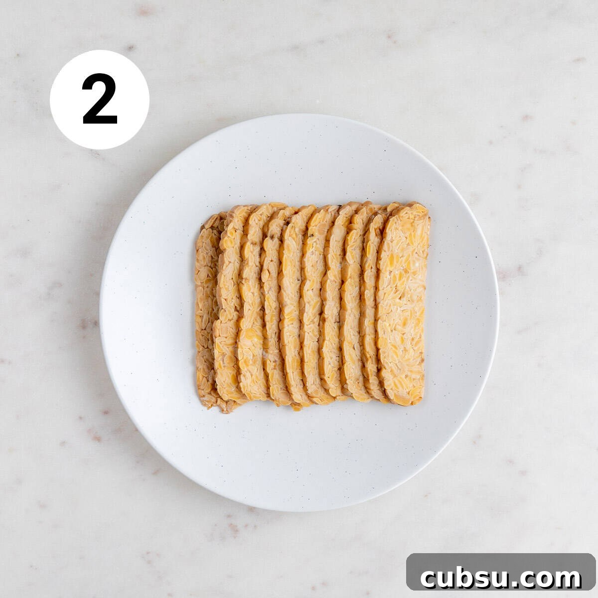 Crispy Tempeh Bacon Recipe: Smoky Vegan Bacon Alternative 5 Shallow dish with tempeh strips.