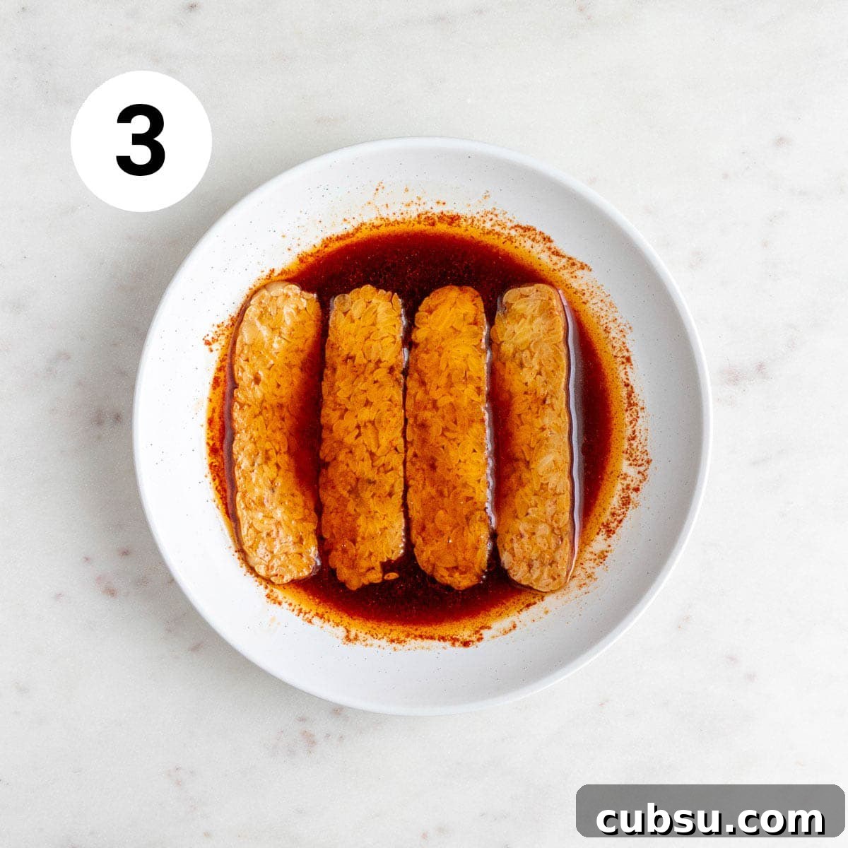 Crispy Tempeh Bacon Recipe: Smoky Vegan Bacon Alternative 6 Tempeh strips soaking in the marinade.
