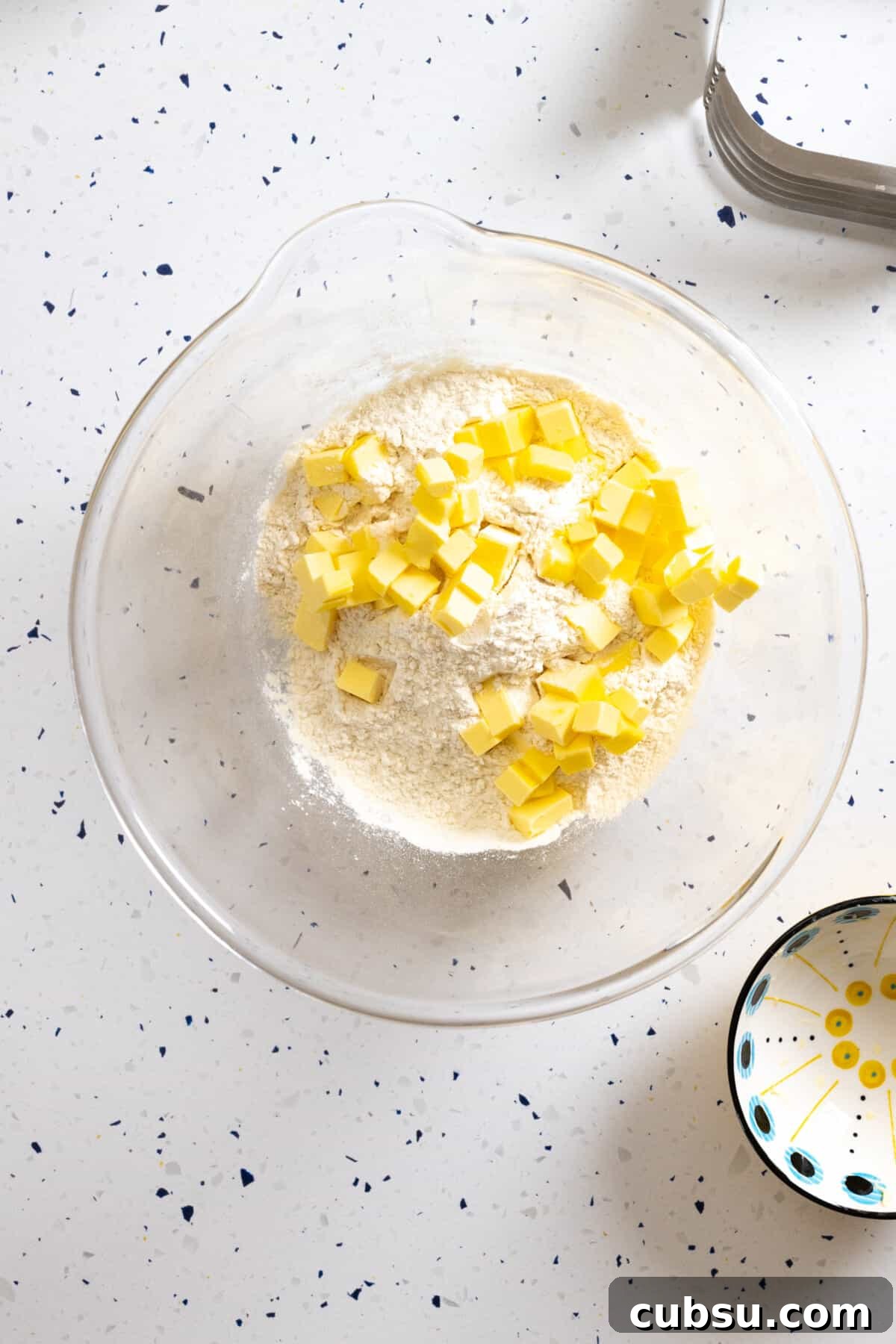 Adding cold cubed butter to dry ingredients