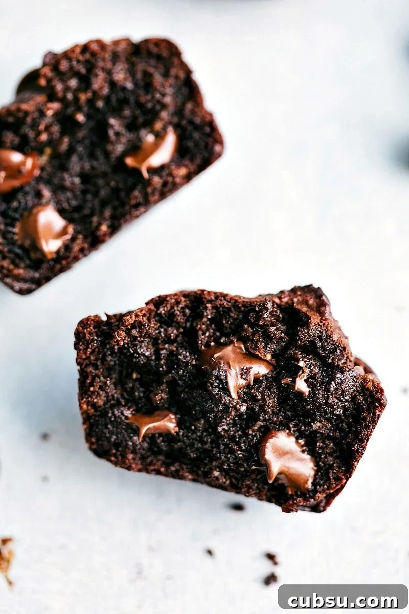 Halved Peanut Butter Chocolate Chip Muffins with Melted Chocolate Chips Inside Halved peanut butter chocolate chip muffins with melted chocolate chips on the inside, showcasing their deliciousness.