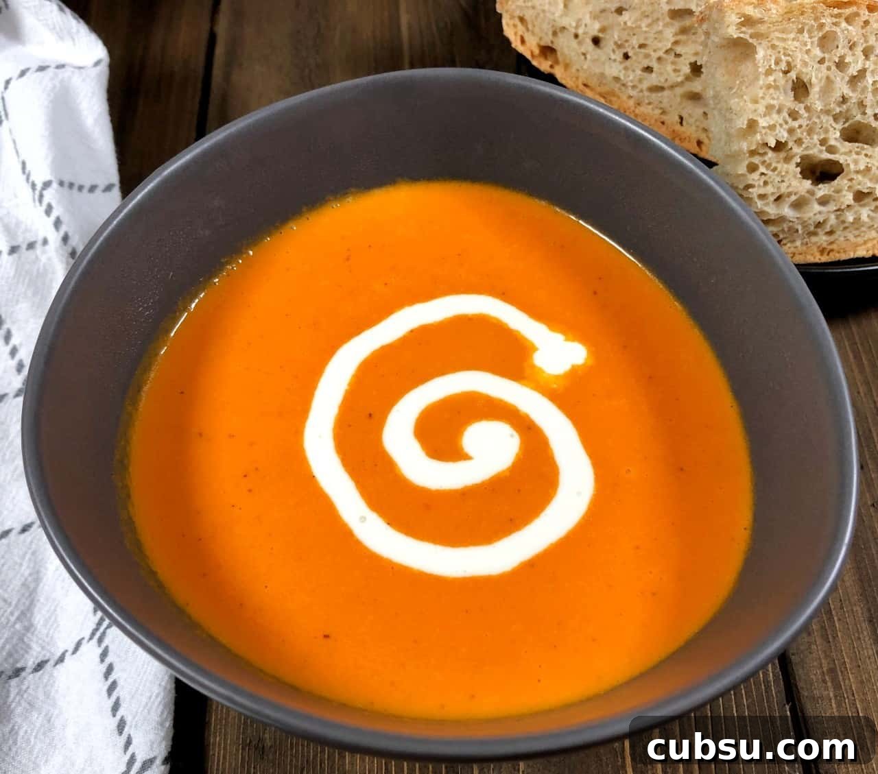 orange tomato soup with bread.