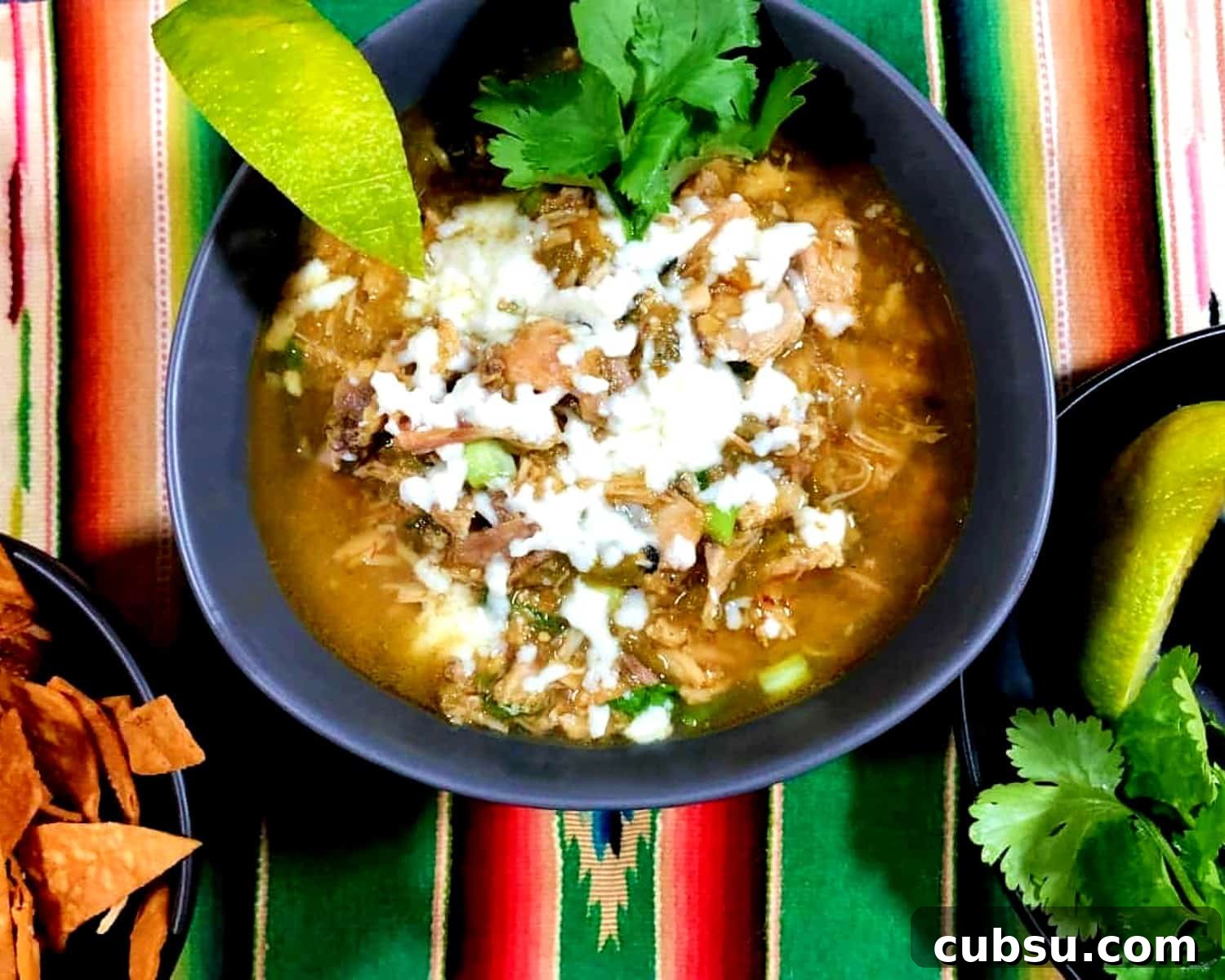 green chile chicken soup with cilantro and lime sides.