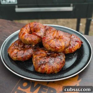 Crispy Chorizo-Stuffed Onion Rings Recipe 17 Several chorizo stuffed onion rings on a plate with a grill in the background