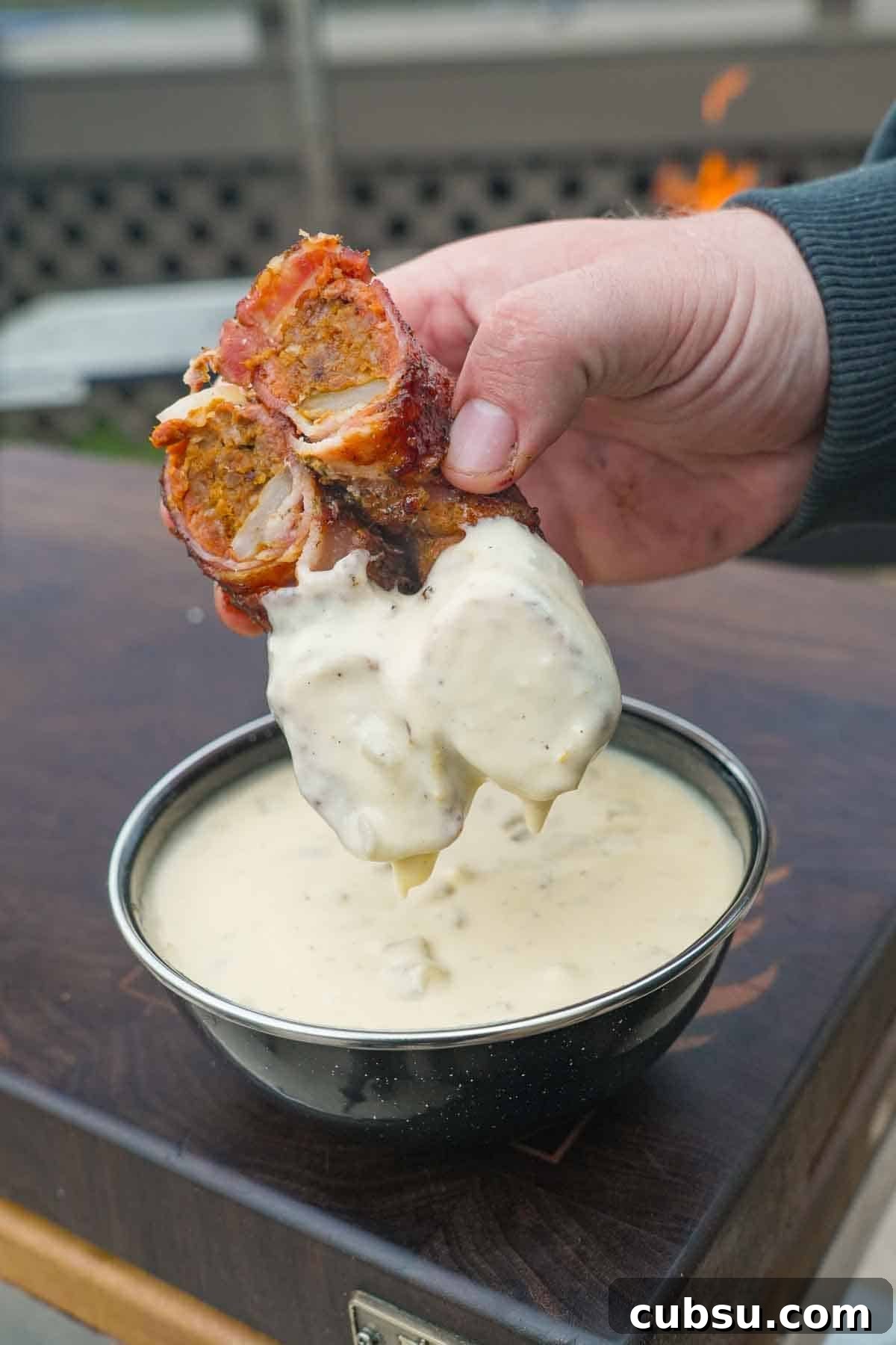 Crispy Chorizo-Stuffed Onion Rings Recipe 9 A chorizo stuffed onion ring sliced in half and dipped in a bowl of homemade queso
