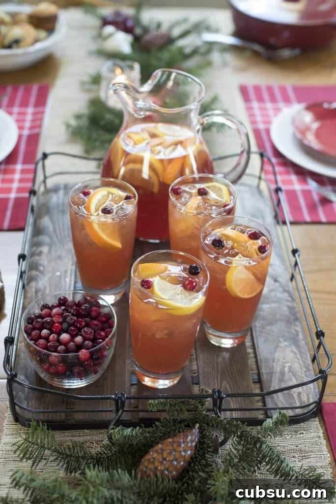 A table topped with festive table settings and a tray of iced tea.