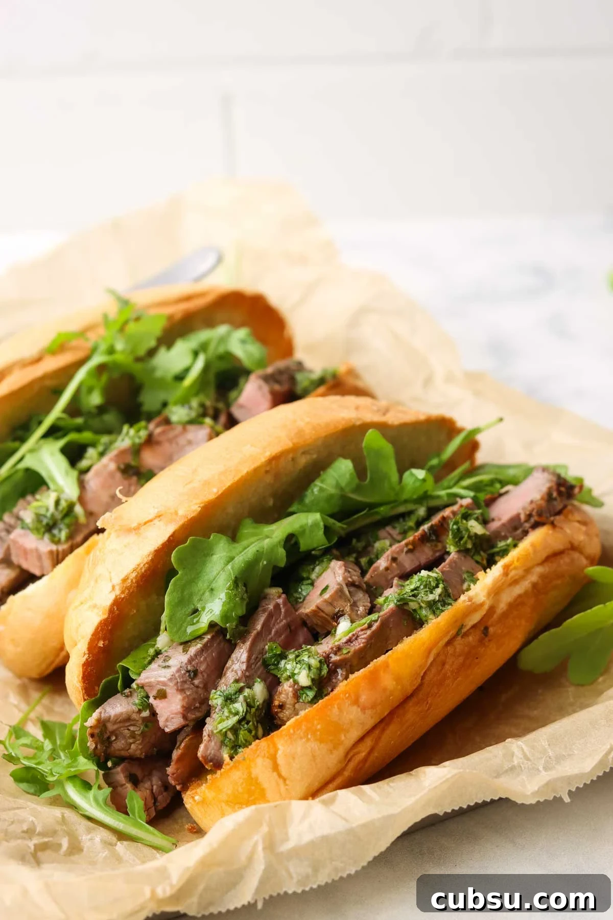Juicy Steak Sandwich with Fresh Chimichurri Sauce 2 two steak sandwiches with chimichurri