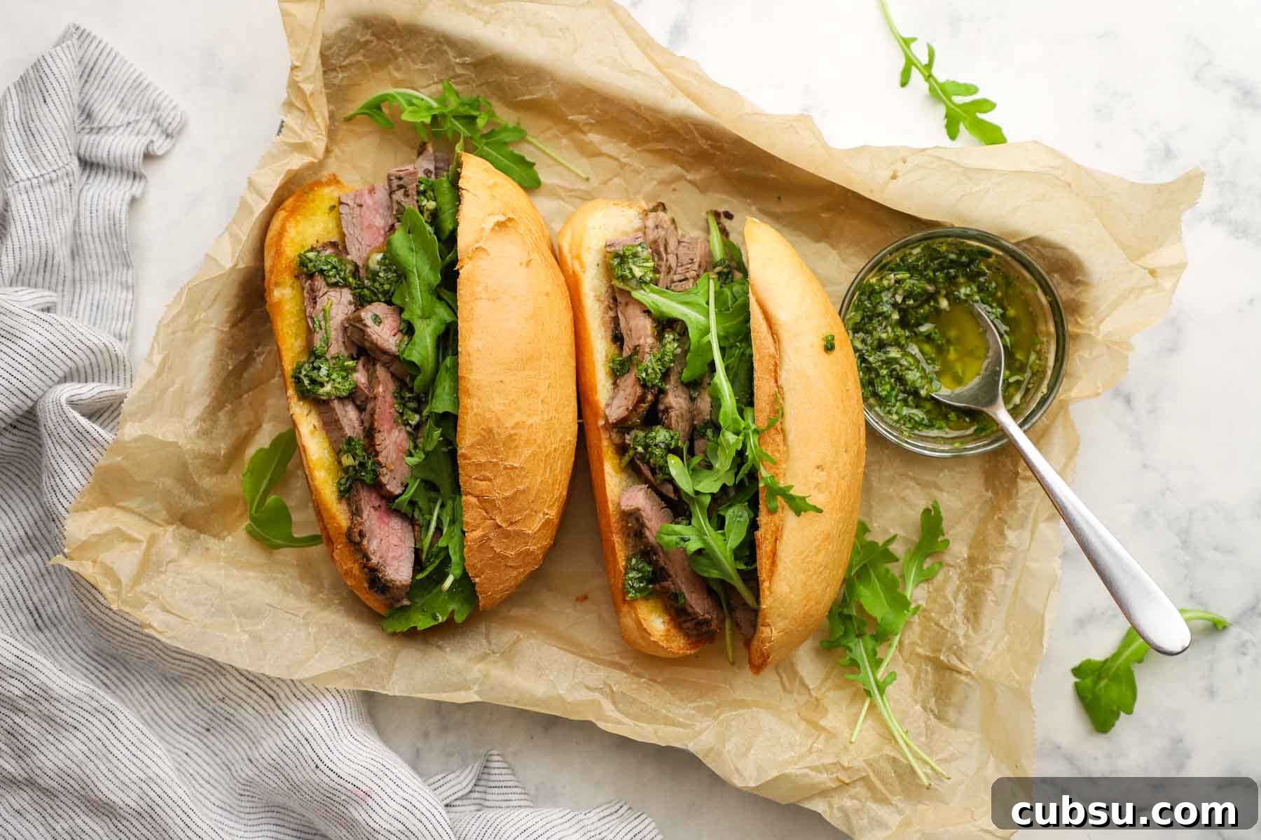 Juicy Steak Sandwich with Fresh Chimichurri Sauce 7 overhead view of two steak sandwiches with chimichurri