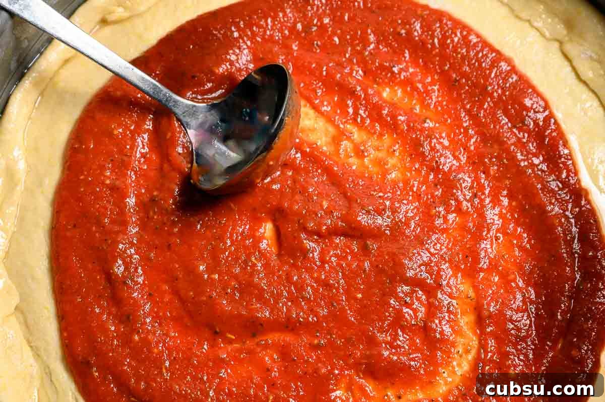 5-Minute Homemade Pizza Sauce Recipe You Can Make Fast 3 5 Minute Pizza Sauce spread on pizza dough.