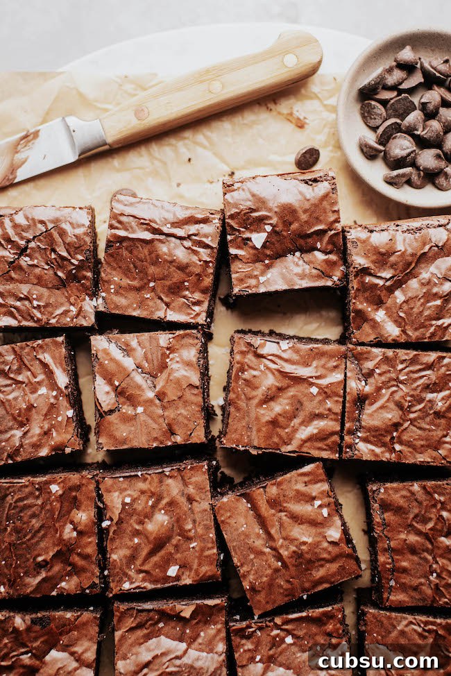 crinkle top brownies sliced into squares on parchment paper