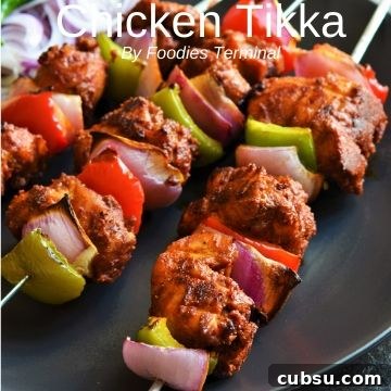 Chicken tikka in metal skewers with veggies