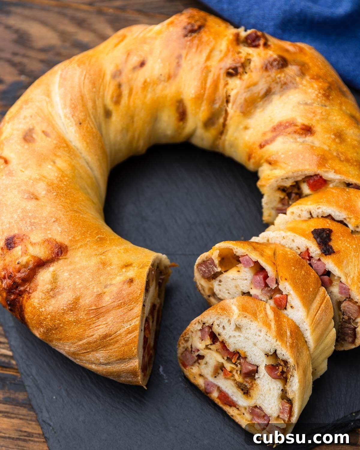 Sliced baked prosciutto bread (lard bread) on serving platter.