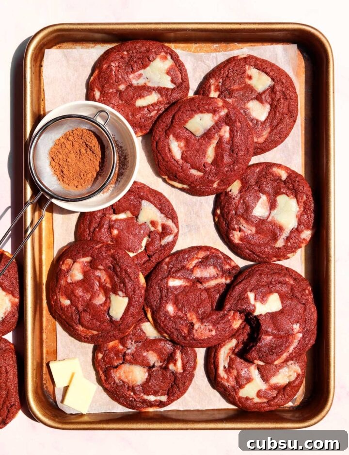 How to Make Classic Red Velvet Cookies with Cream Cheese Filling 2 red velvet cookies on baking sheet