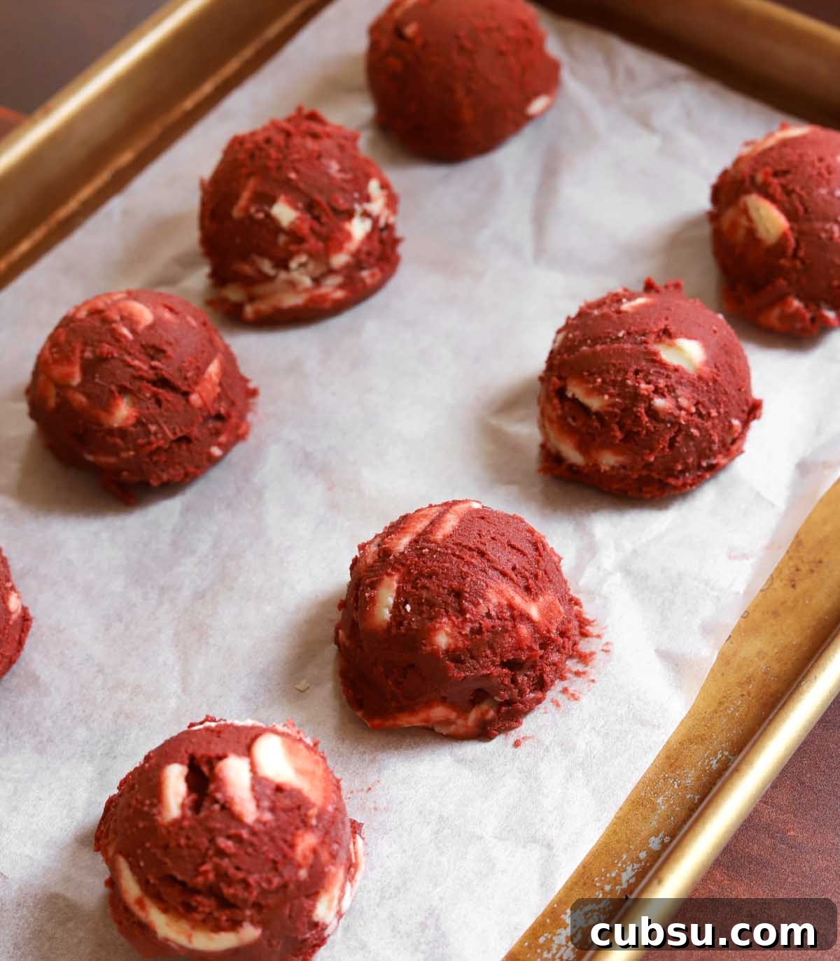 How to Make Classic Red Velvet Cookies with Cream Cheese Filling 8 red velvet cookie dough on parchment lined baking sheet before baking