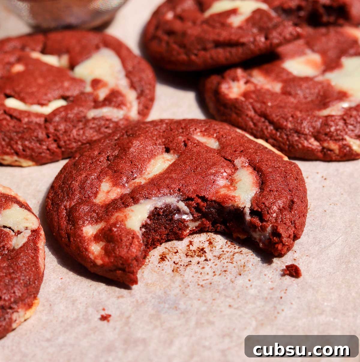 How to Make Classic Red Velvet Cookies with Cream Cheese Filling 9 red velvet cookies with bite on baking sheet