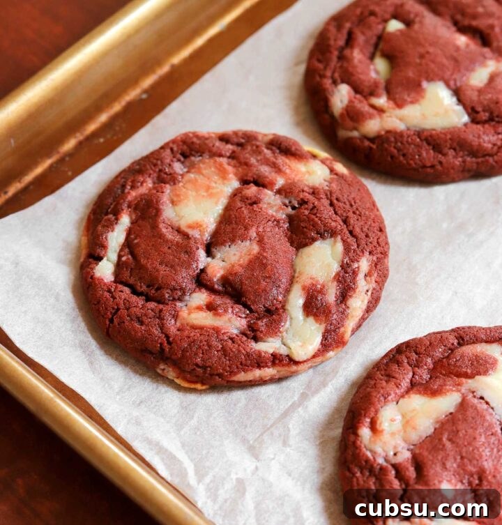 How to Make Classic Red Velvet Cookies with Cream Cheese Filling 10 red velvet cookies on parchment-lined baking sheet