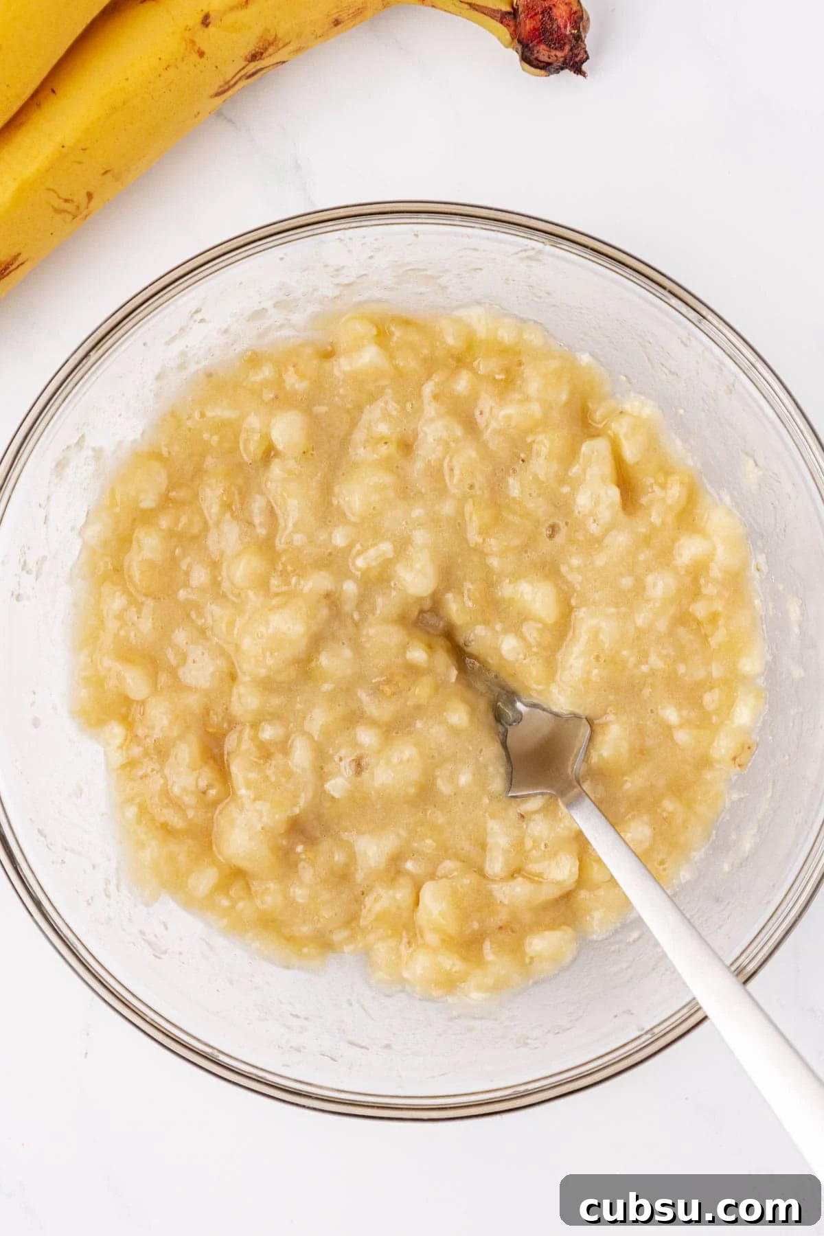 Moist Greek Yogurt Banana Bread Recipe for Tender Loaves 7 mashed banana in a mixing bowl