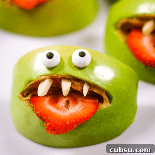 Halloween Apple Monster Snack Ideas 8 A Halloween Apple Monster with a strawberry tong.