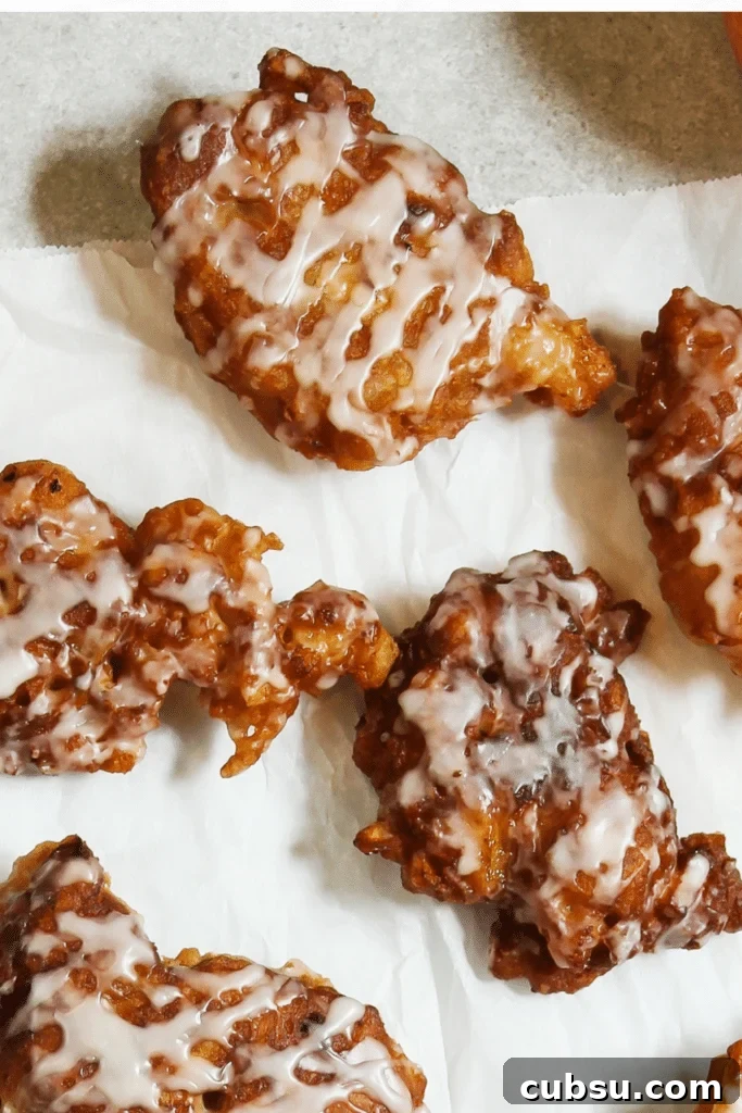 Mouthwatering apple fritters recipe... cooling on parchment paper 