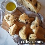 Black Olive & Herb Fougasse: Rustic French Flatbread Recipe 6 Pieces of fougasse on a cutting board with olive oil.
