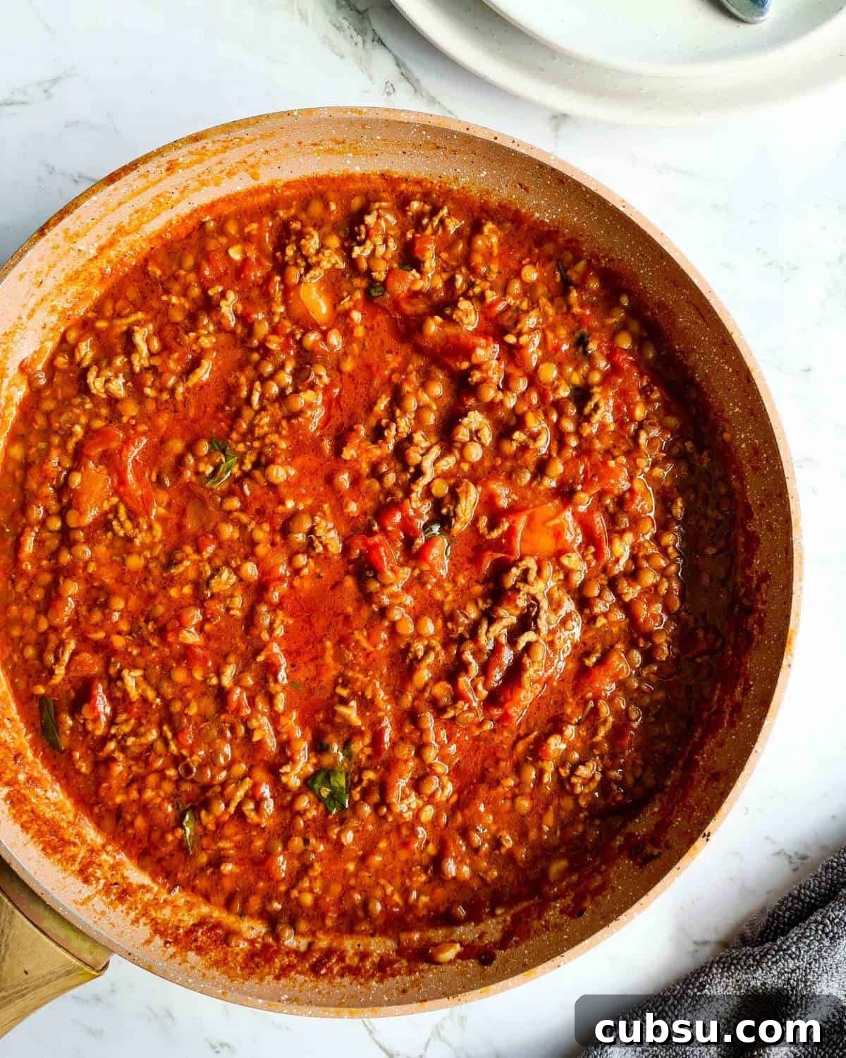 A large pan of cooked bolognese
