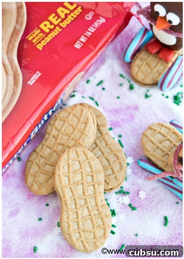 Nutter Butter Penguin Cookies Recipe — Fun Holiday Treats 4 Nutter Butter Cookies on a Pink Background with Sugar