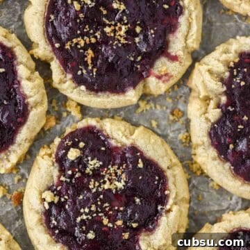 Peanut Butter and Jelly Cookie Recipe — Classic PB&J Cookies 8 overhead shot of peanut butter and jelly cookies on baking sheet