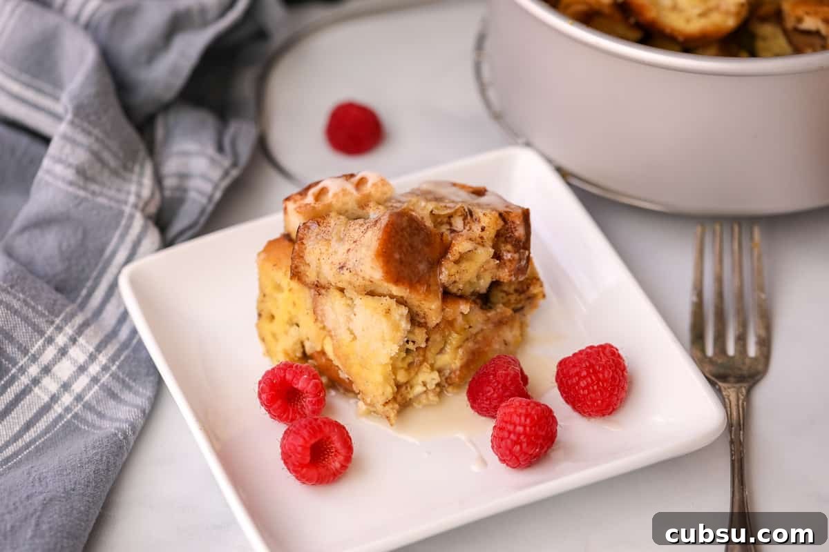 Instant Pot French Toast Instant Pot French Toast Casserole on white plate next to Instant Pot garnished with raspberries.
