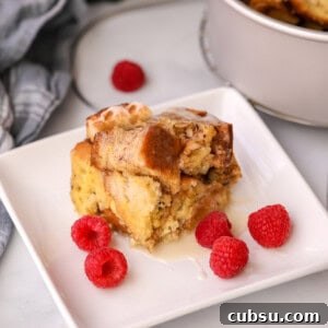 Instant Pot Cinnamon French Toast Casserole: Quick Brunch Recipe 2 Slice of Instant Pot French Toast Casserole on white plate with raspberries.