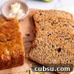 25 Creative Uses for Sourdough Discard: Recipes & Tips 16 Slices of sourdough zucchini bread on a cutting board with a dish of butter.