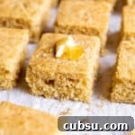 25 Creative Uses for Sourdough Discard: Recipes & Tips 18 A piece of sourdough cornbread with some butter and honey on top.