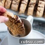 25 Creative Uses for Sourdough Discard: Recipes & Tips 5 Sourdough almond biscotti being dipped in a cup of coffee.