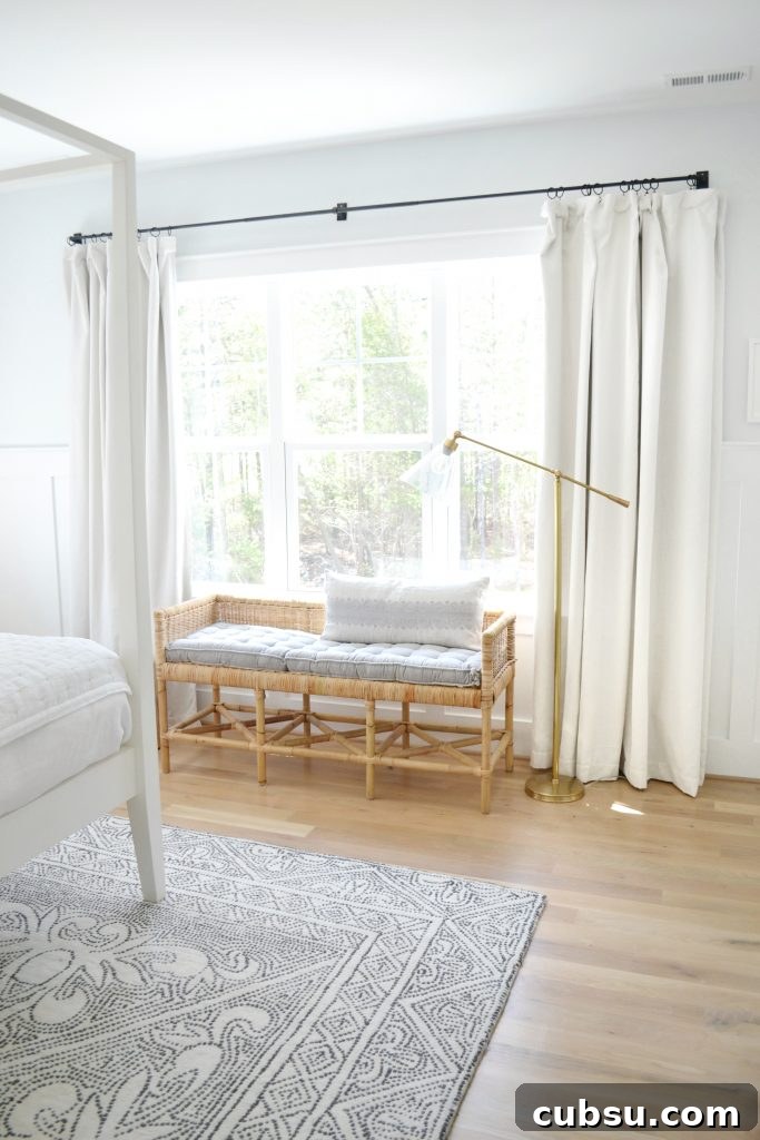 the shore bench by Serena and lily in a neutral bedroom under a window