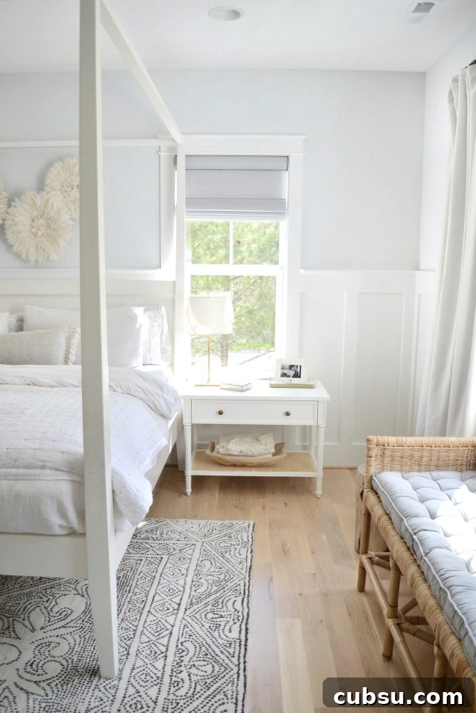 a white harbour cane nightstand, mirabelle rug and a neutral bedroom