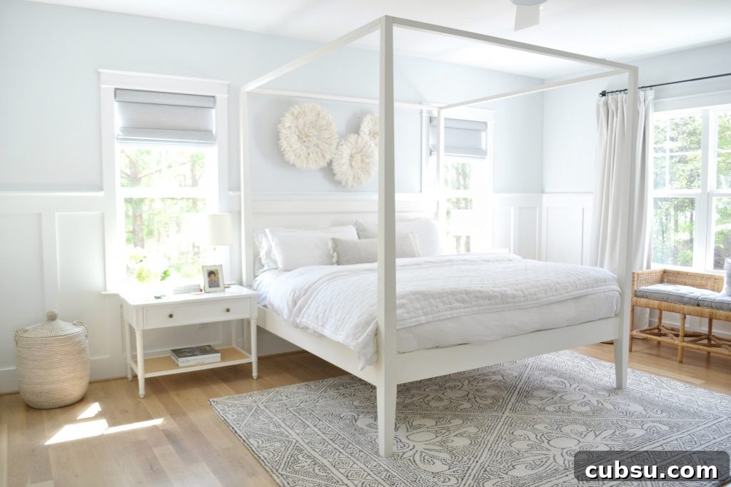 white canopy bed in a neutral bedroom